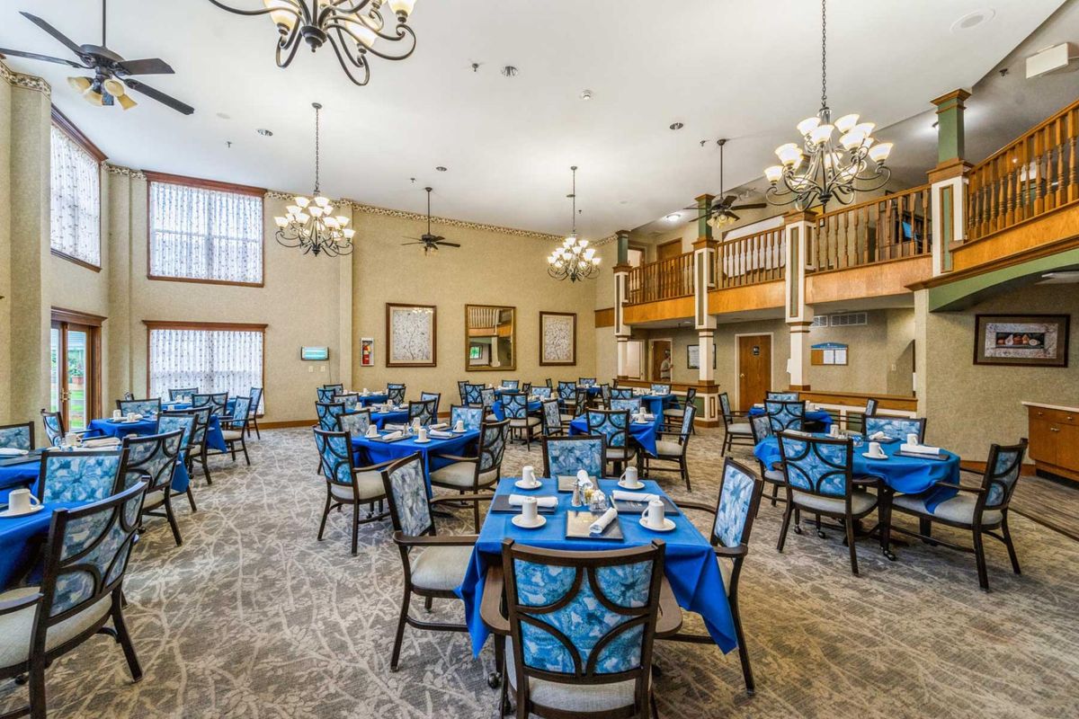An elegant dining room with blue-themed decor and chandeliers.