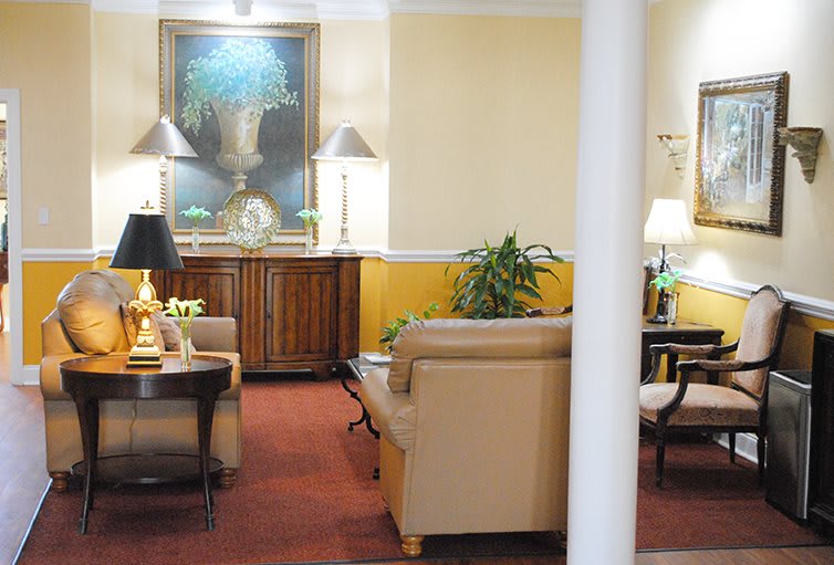 A cozy living room featuring comfortable seating, warm lighting, and elegant decor.