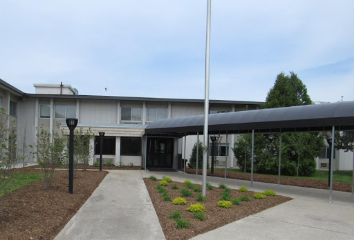 A view of a modern building with a landscaped area and pathway.