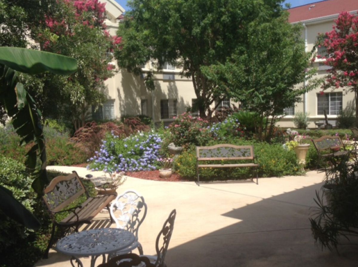 A tranquil courtyard with seating and lush greenery.