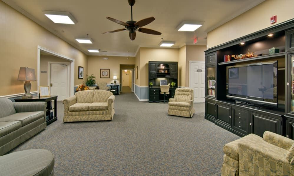 A cozy lobby area with comfortable seating and a ceiling fan.