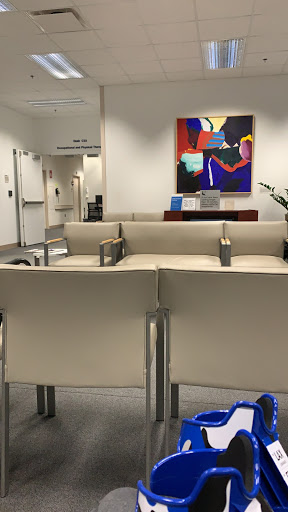 A minimalist waiting area featuring contemporary furniture and vibrant artwork.
