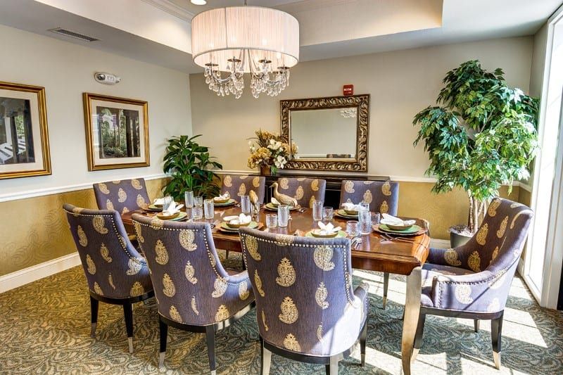 A luxurious dining room with an elegant table setting and chandelier.