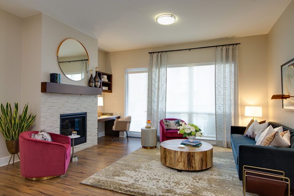 A modern living room with stylish furniture, featuring a cozy fireplace and a unique wooden coffee table.