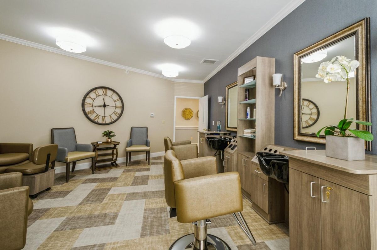 A modern salon interior with styling stations and comfortable seating.