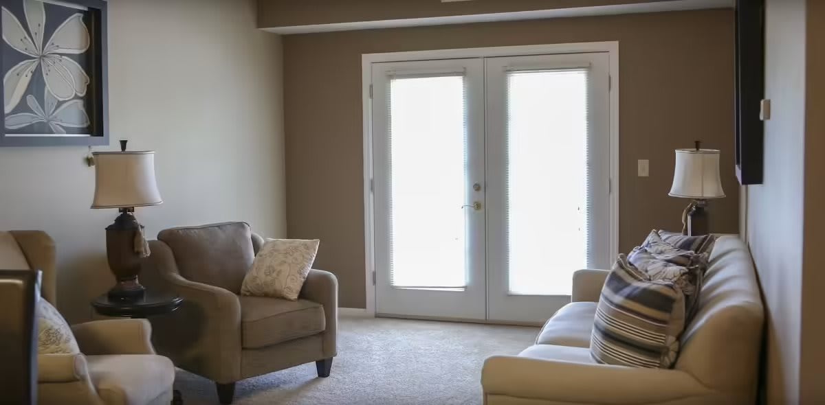 A cozy living room with comfortable seating and large windows.