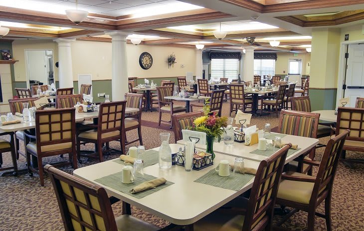 A spacious and well-decorated dining area featuring neatly arranged tables and chairs.