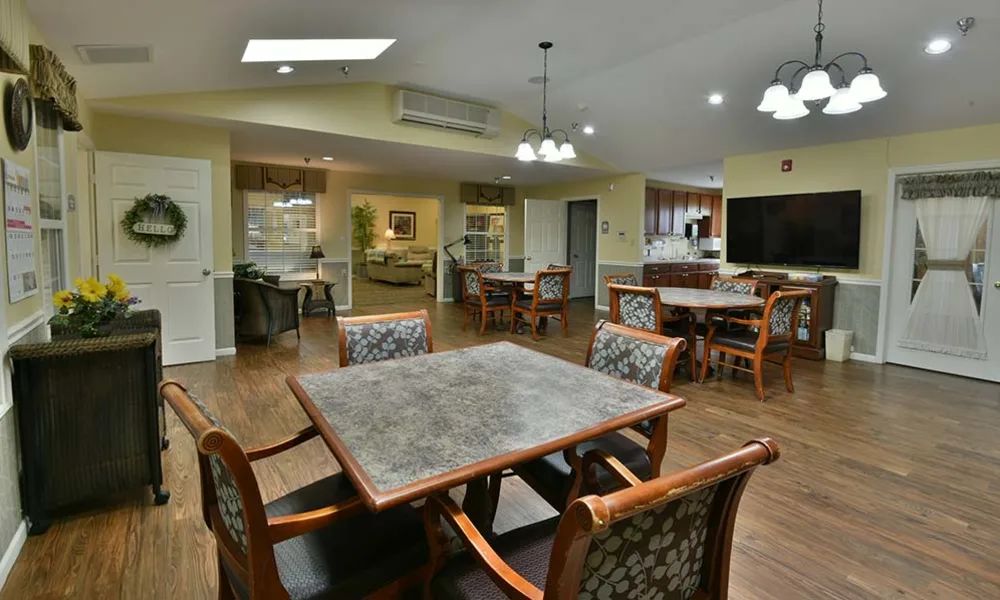 A cozy dining area with wooden furniture and warm lighting.