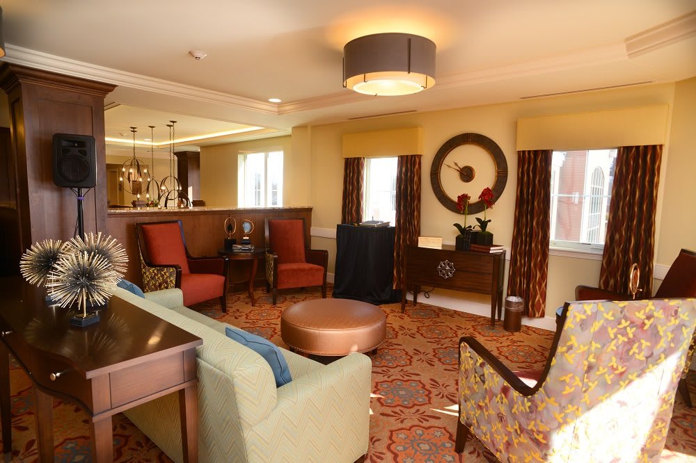 A cozy and elegantly decorated living room with comfortable seating and warm lighting.
