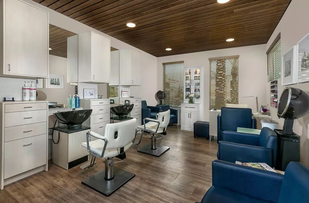 A modern salon interior with stylish furniture and hair styling stations.