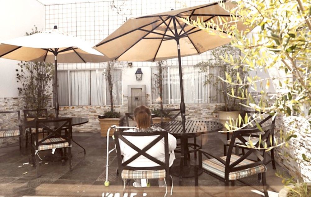 A peaceful outdoor patio area with seating and umbrellas, perfect for relaxation.