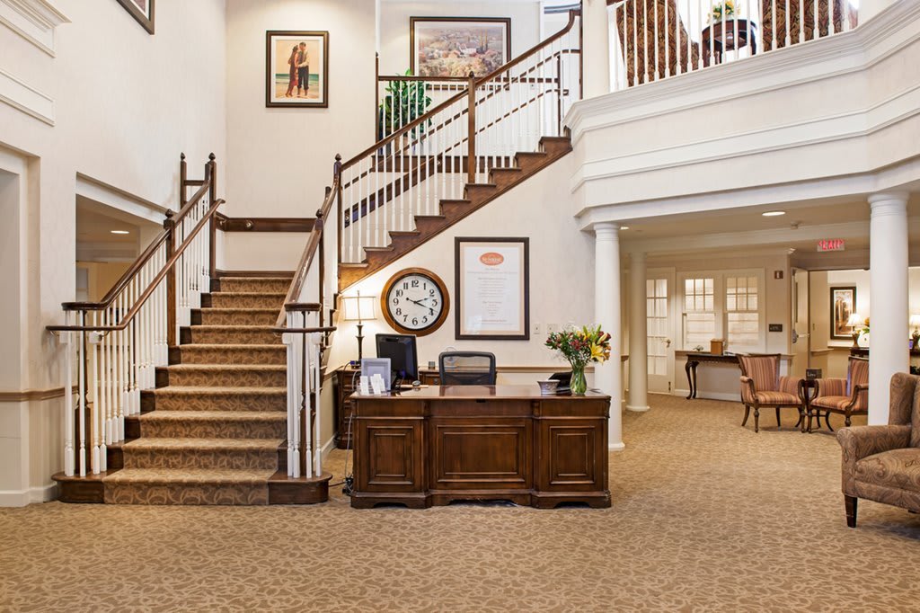 A welcoming lobby area featuring a central staircase and reception desk.