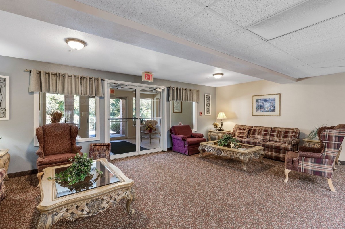 A cozy lobby area with comfortable seating and large windows.