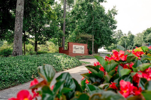 A welcoming entrance surrounded by lush greenery and vibrant flowers.