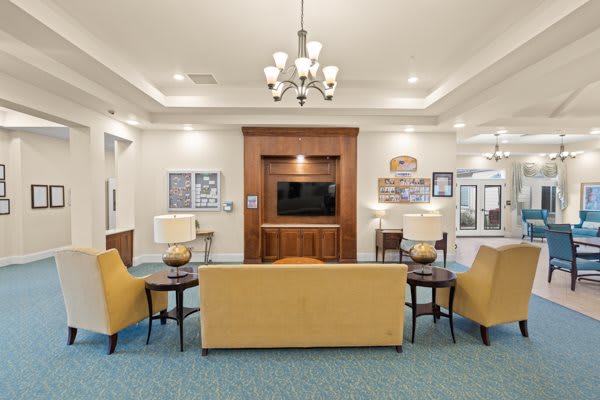 A modern living room with comfortable seating and a television.
