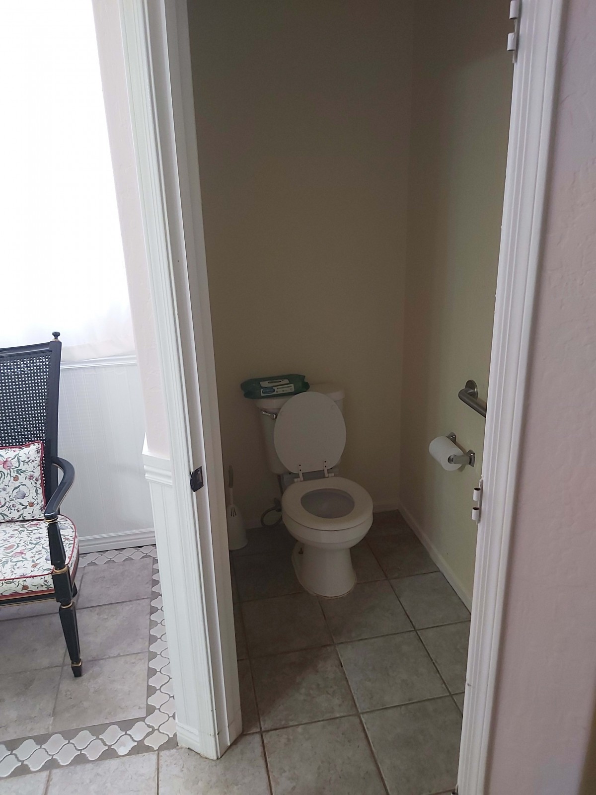 A small bathroom with a toilet, viewed from an open doorway.