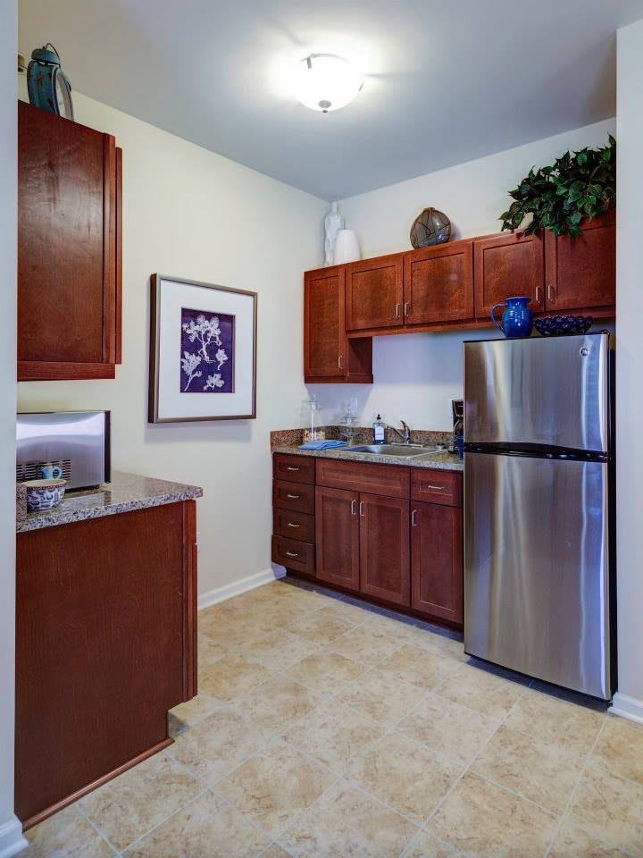A modern kitchen with wooden cabinets and stainless steel appliances.
