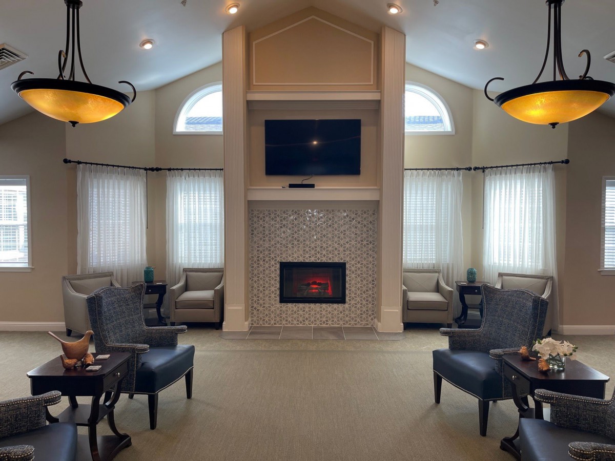 A cozy living room with a fireplace, television, and comfortable seating.