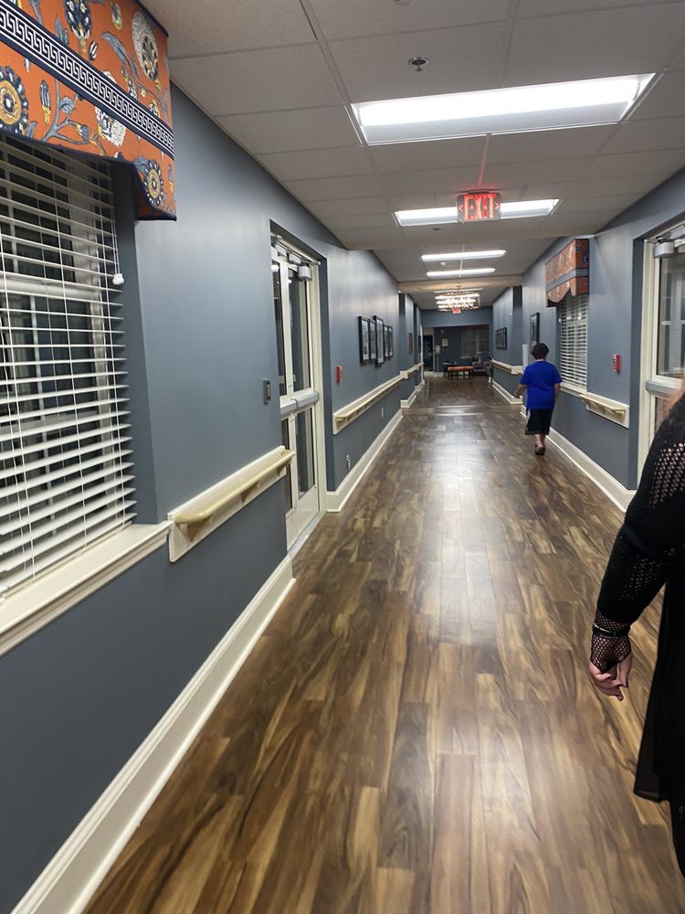 A long hallway with people walking in a building interior.