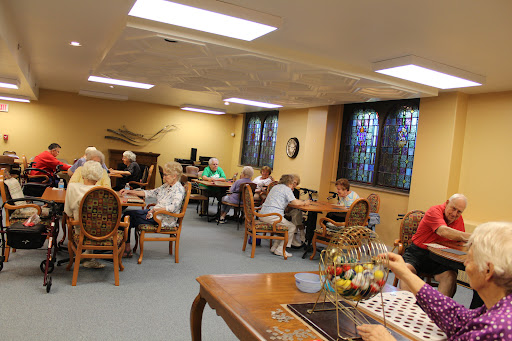 Seniors enjoying a lively game of bingo in a community activity room.