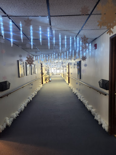 A beautifully decorated winter-themed hallway with blue lights and snowflake ornaments.