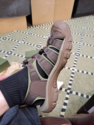 A comfortable outdoor sandal paired with a black sock.