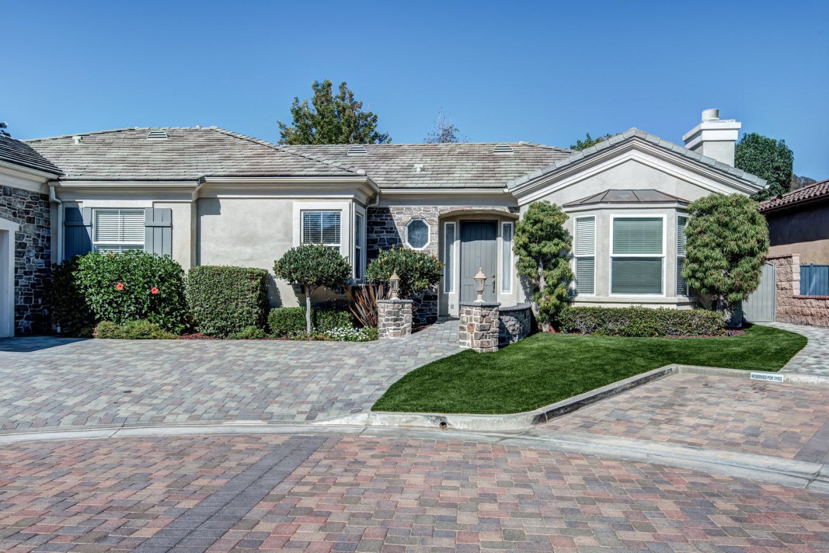 A well-maintained single-story house with a tidy lawn and driveway.