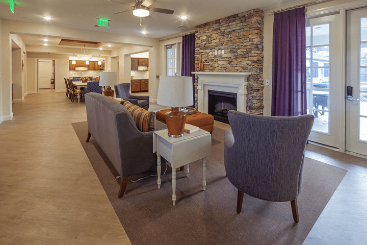A modern living room with a cozy fireplace and stylish furniture.