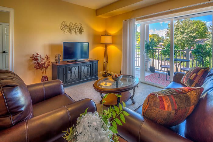 Cozy living room with modern decor and access to a balcony.