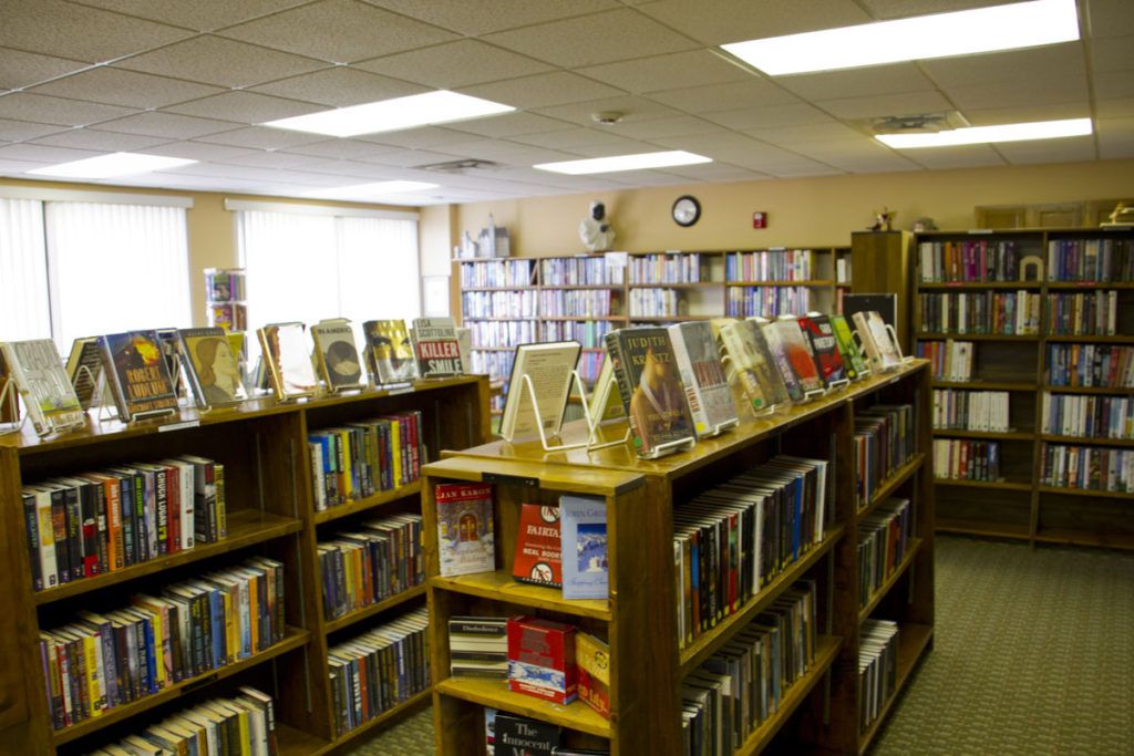 A library interior with rows of bookshelves filled with various books.