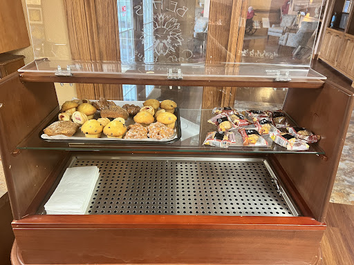 A tempting bakery display featuring cookies and muffins.
