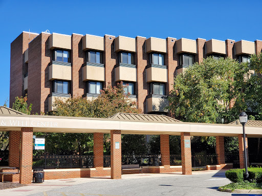 A modern hotel building with a welcoming entrance and lush greenery.