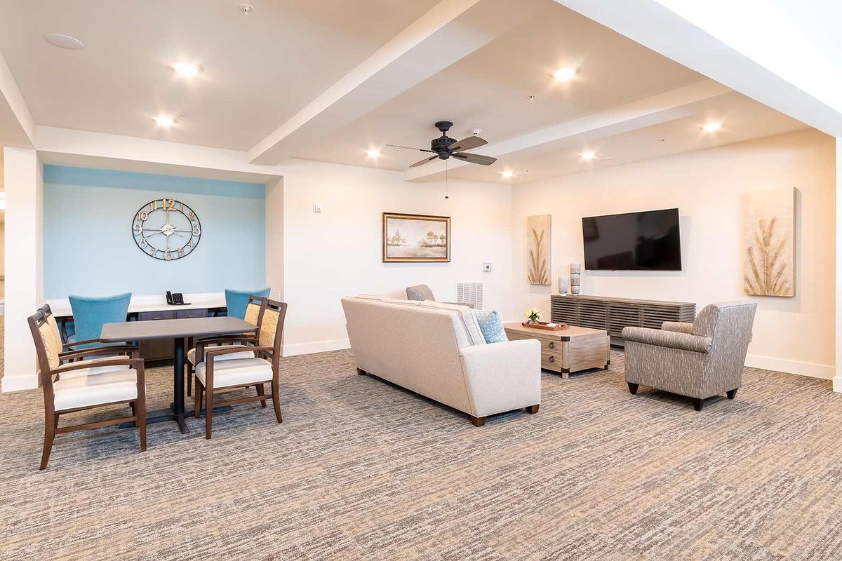 A modern living room with a cozy seating area, dining space, and elegant decor.