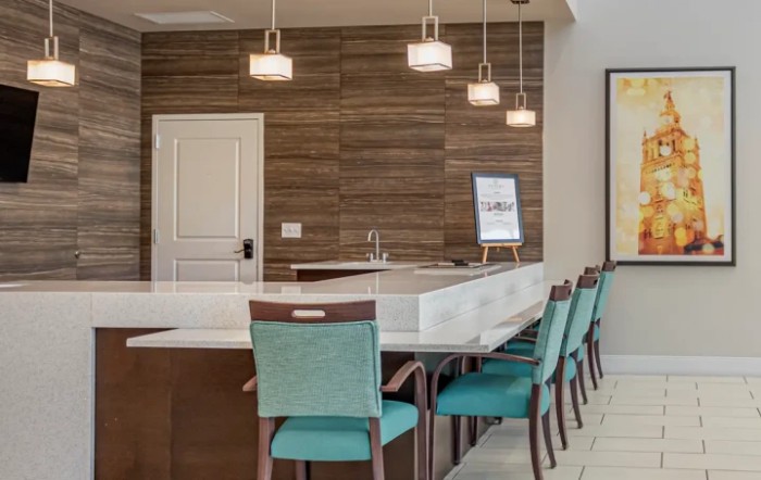 Modern kitchen with a sleek dining area and stylish pendant lighting.