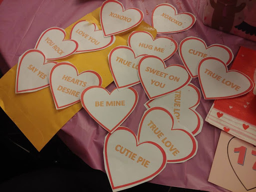 A collection of heart-shaped love notes and decorations for a Valentine's celebration.