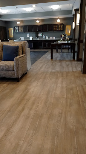 A cozy living space featuring a comfortable chair and stylish flooring.
