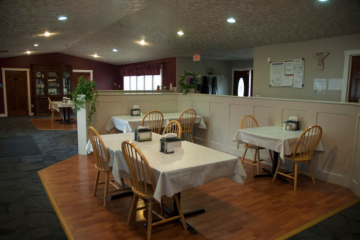 Cozy restaurant interior with neatly arranged tables and wooden chairs.