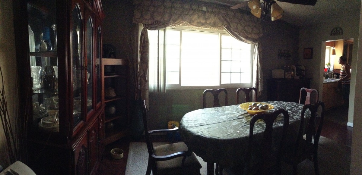 A cozy dining room with a table and chairs near a sunlit window.
