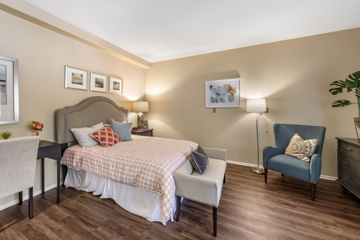 A cozy and stylish bedroom with modern decor featuring a comfortable bed, elegant furniture, and warm lighting.