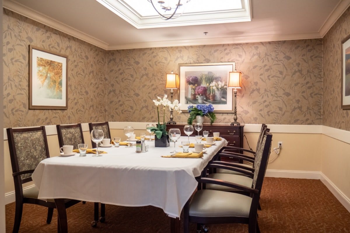 A beautifully set dining room table with elegant decor and soft lighting.