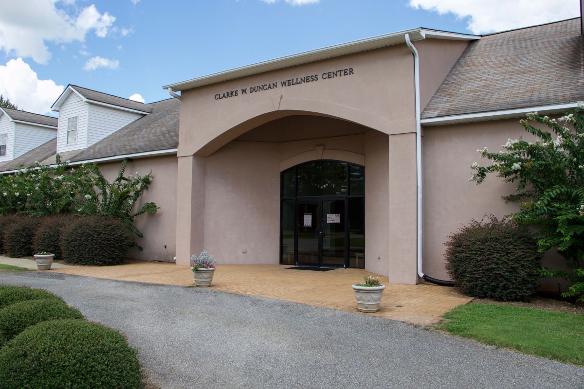 The entrance of a library building with a pathway leading to the doors.