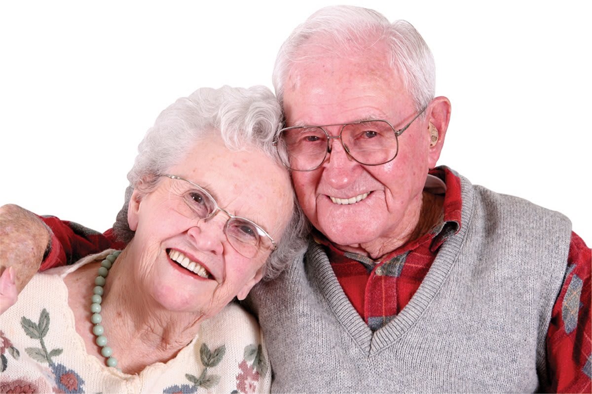 An elderly couple smiling warmly, showcasing a sense of togetherness.