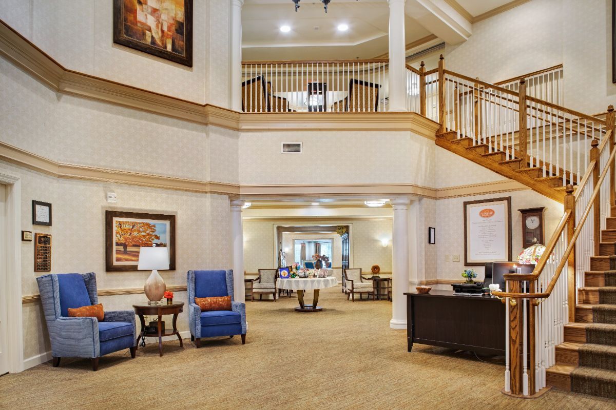 A spacious lobby area with seating and a staircase.