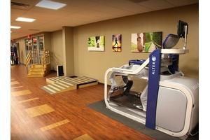 A modern gym interior with exercise equipment and a treadmill.