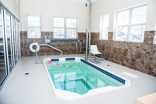 A serene indoor therapy pool designed for relaxation and accessibility.