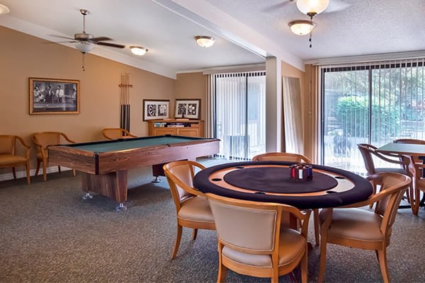 A cozy game room featuring a billiards table and a poker table, perfect for leisure and entertainment.