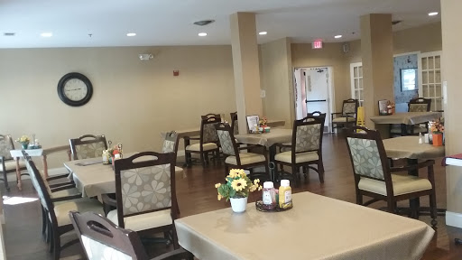 A cozy dining area featuring tables and chairs, creating a welcoming atmosphere for gatherings.