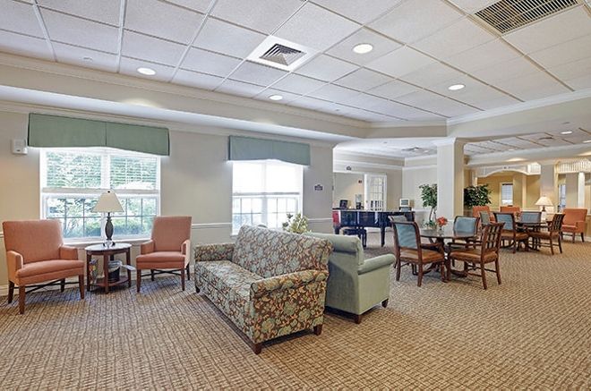 A well-lit living room with comfortable seating and elegant decor.