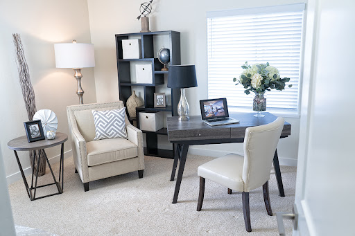 A stylish home office setup featuring modern furniture and a cozy atmosphere.