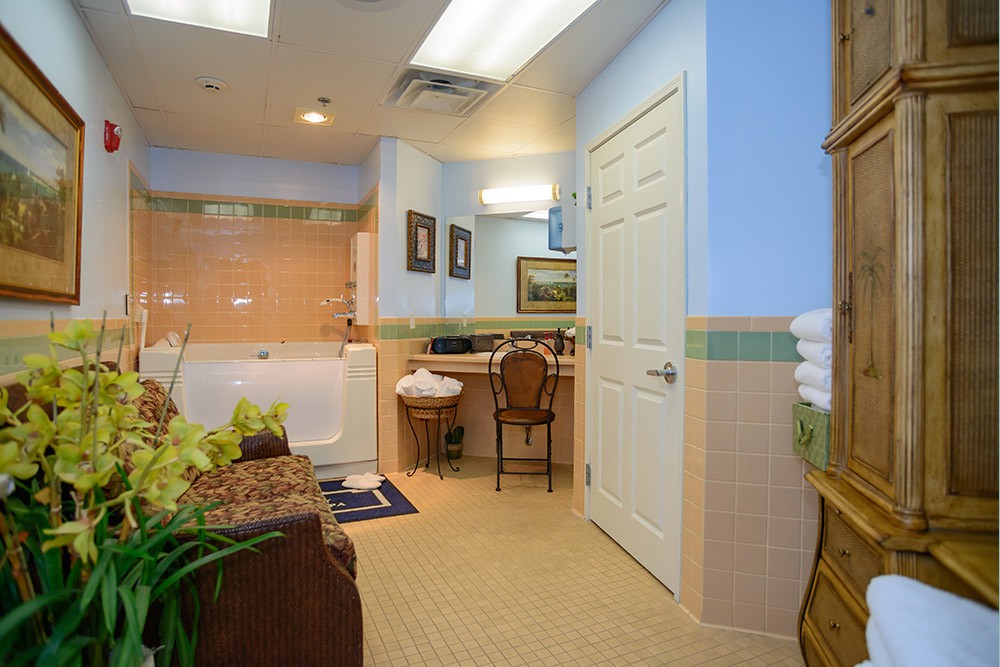 A well-decorated bathroom with a bathtub, vanity area, and elegant furnishings.